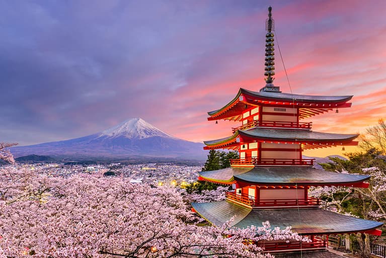 Fujiyoshida, Japan at Chureito Pagoda and Mt. Fuji in the spring with cherry blossoms.