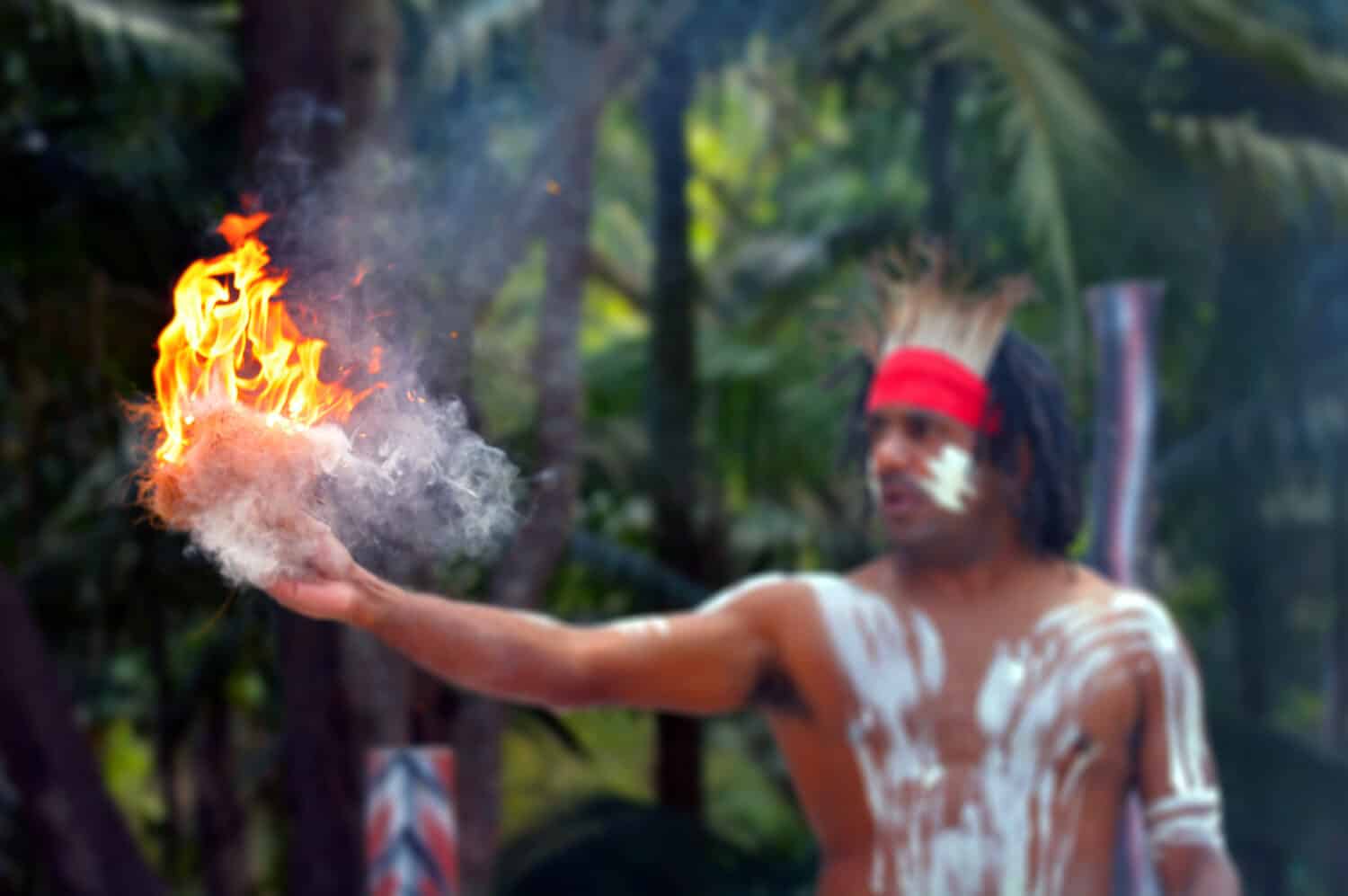 Aboriginal Australian adult man showing fire making craft on Aboriginal culture show in the tropical far north of  Queensland, Australia.