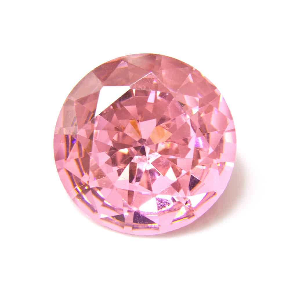 Pink diamond stone isolated on a white studio background.