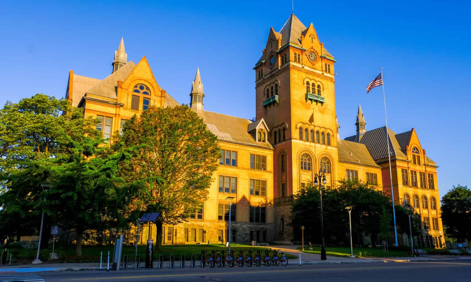 An exotic, antique-style castle with golden dawn sunlight. The castle is known as 'Old Main" building located in Wayne State University area, Midtown, Detroit, Michigan, USA.