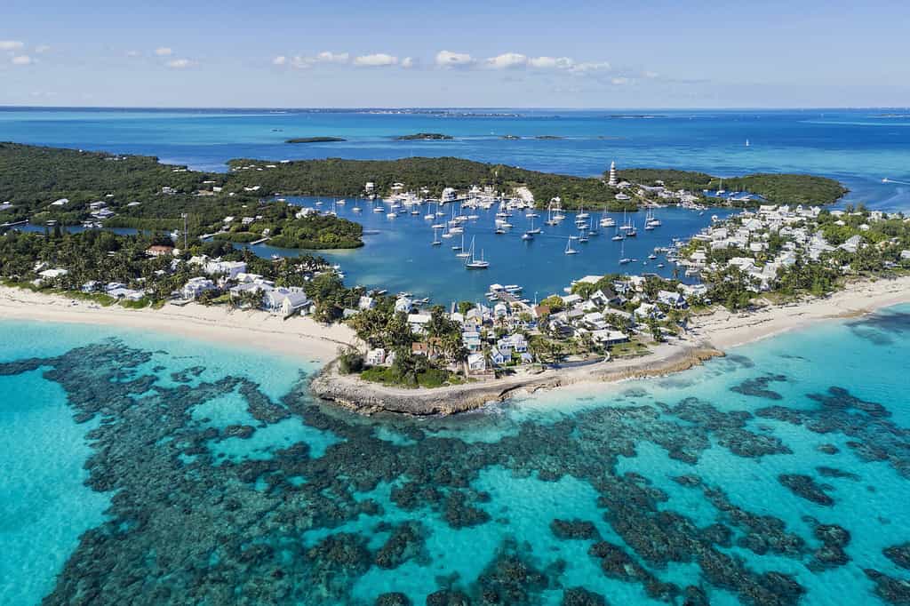 Aerial view of the harbour, beach and lighthouse in Hope Town on Elbow Cay off the island of Abaco, Bahamas.