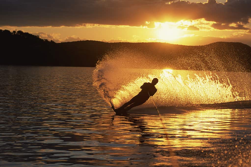 Silhouette of person waterskiing