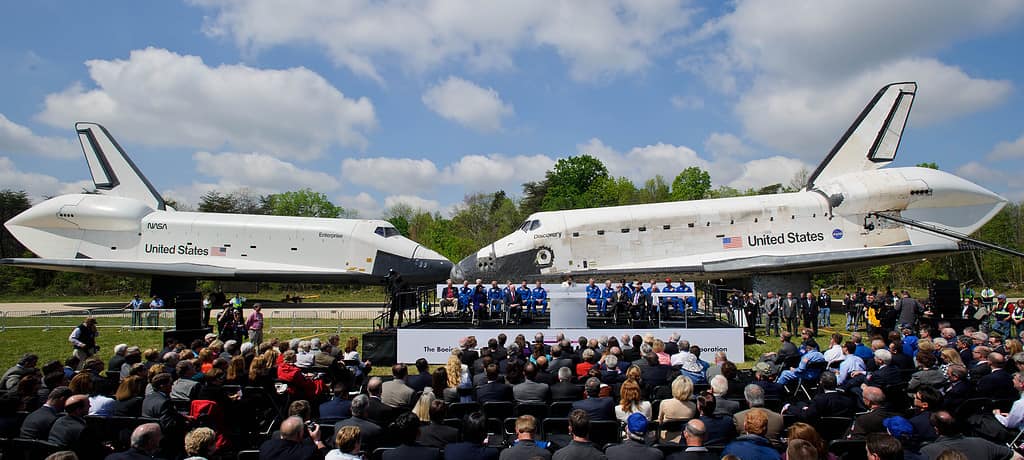 Space Shuttles Enterprise, left, and Discovery meet nose-to-nose at the beginning of a transfer ceremony at the Smithsonian's Steven F. Udvar-Hazy Center, Thursday, April 19, 2012, in Chantilly, Va. Space shuttle Discovery, the first orbiter retired from NASA’s shuttle fleet, completed 39 missions, spent 365 days in space, orbited the Earth 5,830 times, and traveled 148,221,675 miles will take the place of Enterprise at the center to commemorate past achievements in space and to educate and inspire future generations of explorers at the center. Photo Credit: (NASA/Paul E. Alers)