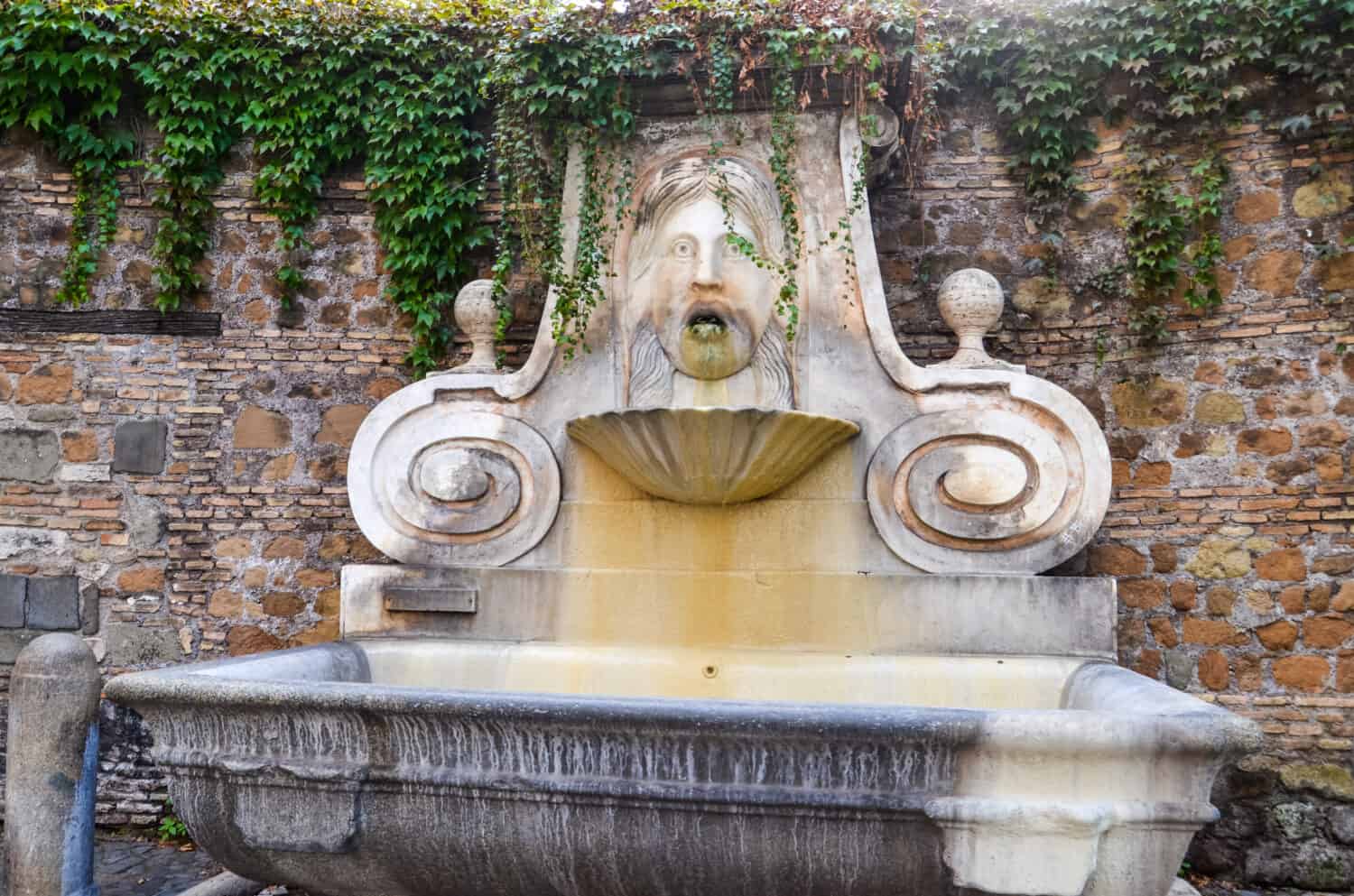 Drinking fountain with image of head in Rome