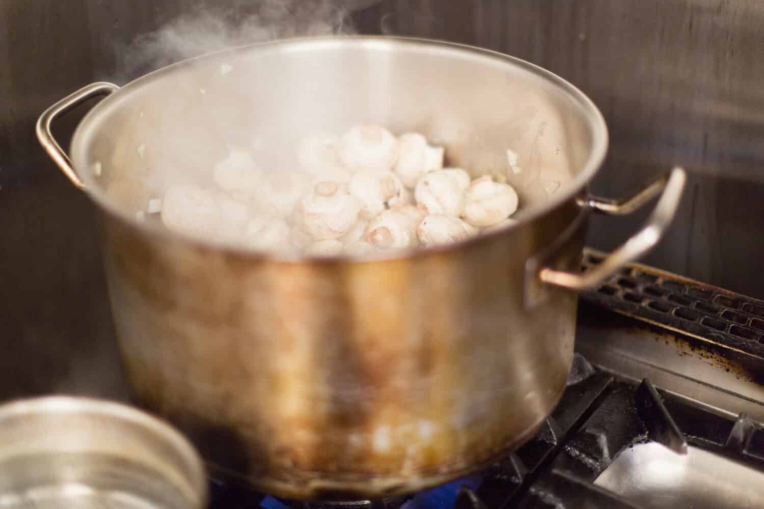 Mushrooms boiling away in a pot.