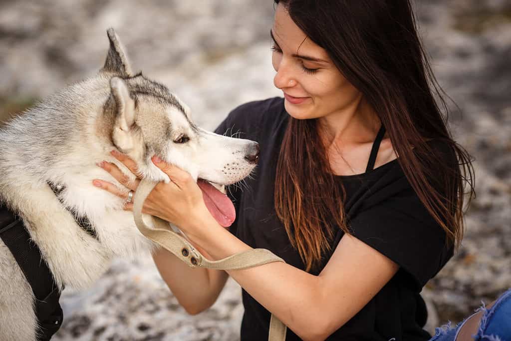 Beautiful girl plays with a Native American Indian Dog
