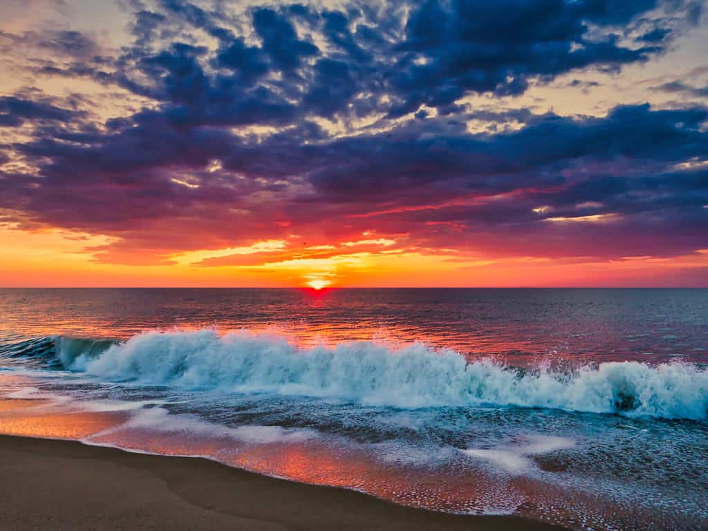 Sunrise from the Bethany Beach, Delaware, with dramatic skycap and surf.