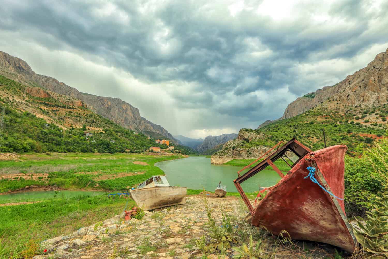 Landscape of The Euphrates River with fishing boats in Kemaliye, Erzincan, Turkey. ( Turkish: Firat Nehri ). The Euphrates receives most of its water in the form of rainfall and melting snow.