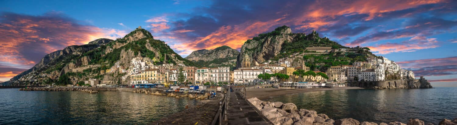 Beautiful panorama of Amalfi, the main town of the coast on which it is located taken from the sea. Situated in province of Salerno, in the region of Campania, Italy, on the Gulf of Salerno at sunset.