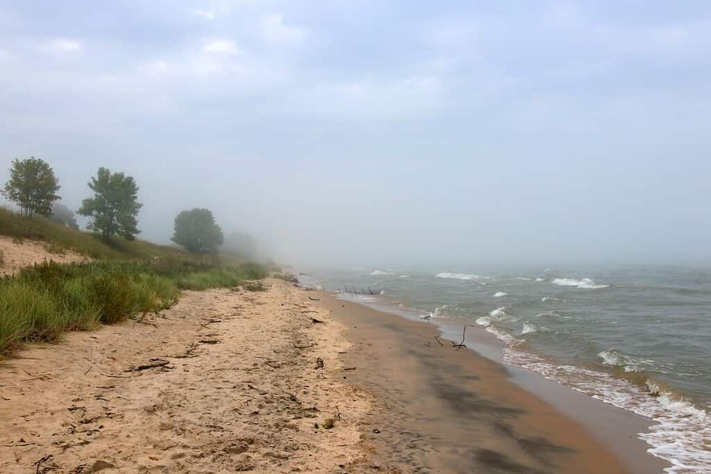 Beautiful midwest nature background. Summer landscape with mist over the lake Michigan and beach at Kohler-Andrae State Park, Sheboygan area, Wisconsin, USA.
