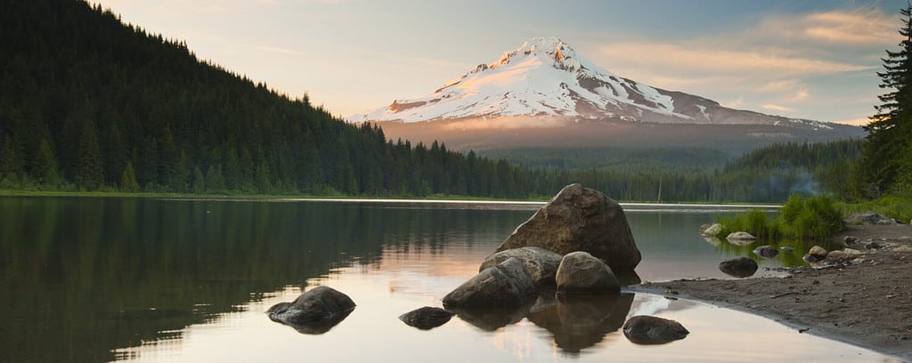 The volcano mountain Mt. Hood, in Oregon, USA. At sunset with reflection on the water of the Trillium lake.