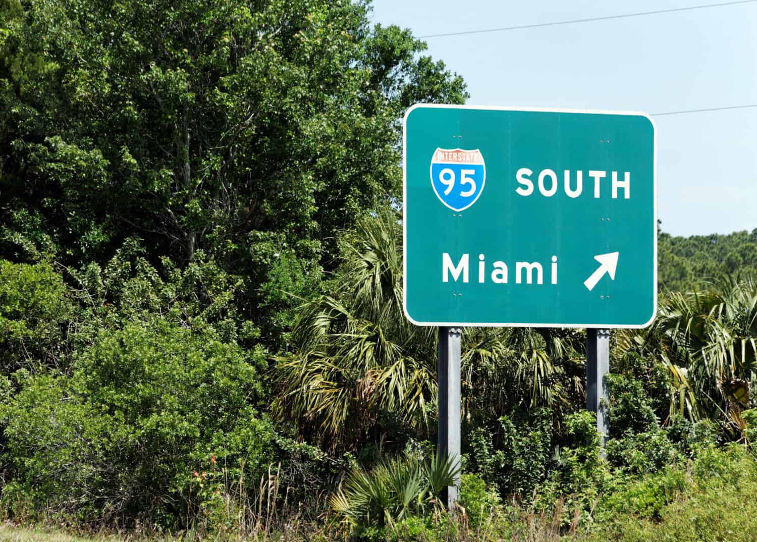 An interstate sign points the way to Miami, Florida.
