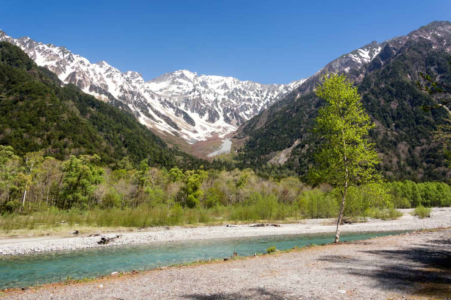 View on valley of Kamikochi, Chubu Sangaku National Park, Nagano, Japan. Beautiful surroundings in the Japan Alps for hiking, walking and to enjoy nature to the fullest. To be in harmony with nature.