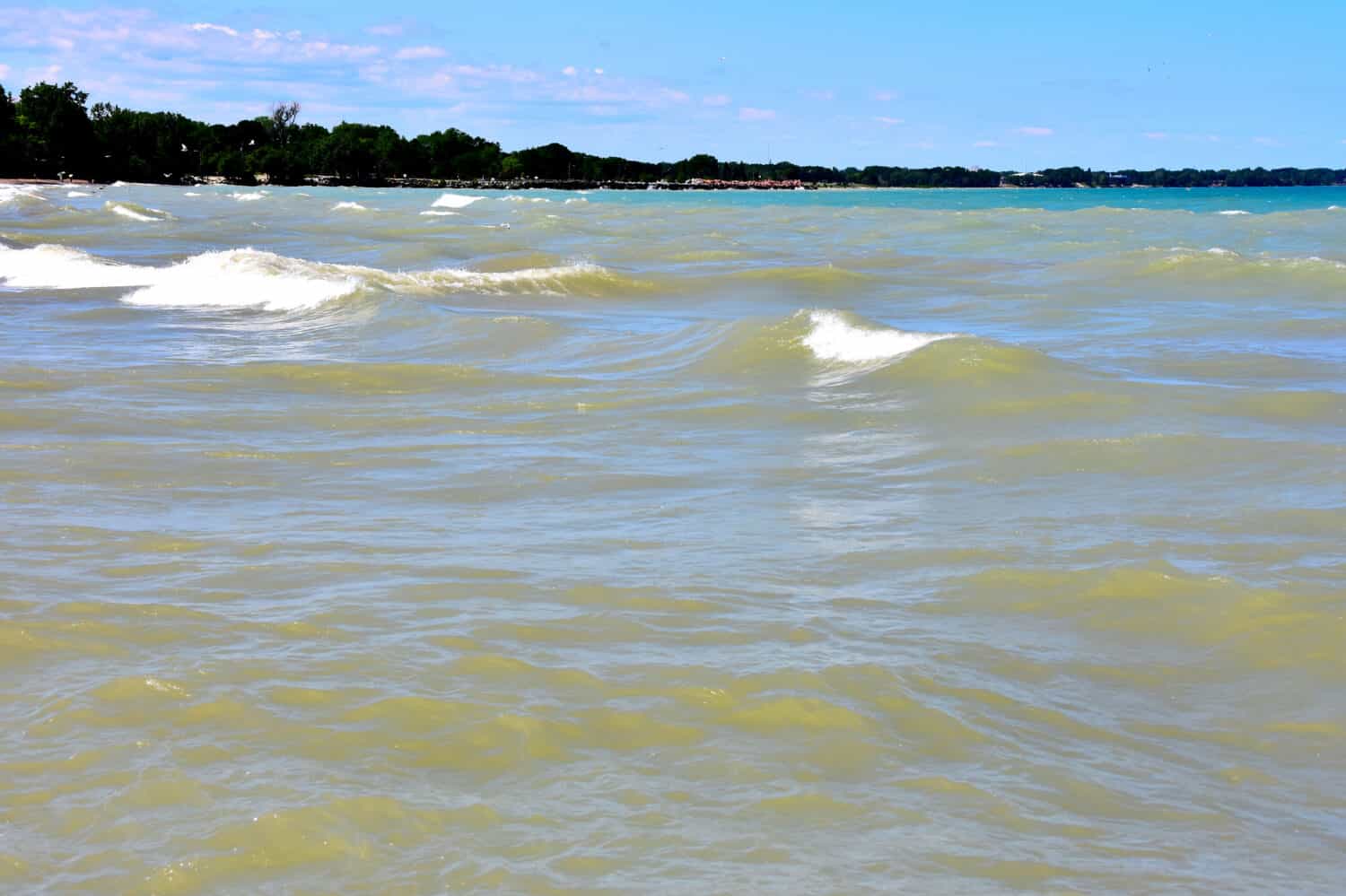 Large waves crashing along the Lake Michigan Shoreline at Simons Island Park in Kenosha Wisconsin on a beautiful sunny afternoon.