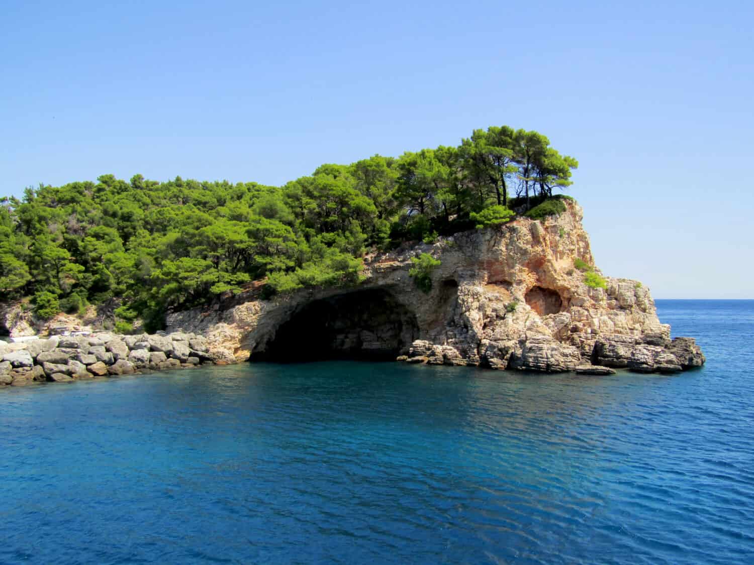 The famous blue cave of Alonissos Island in Greece, a part of National Marine Park, with full of impressive and beautiful summer colours of sea.