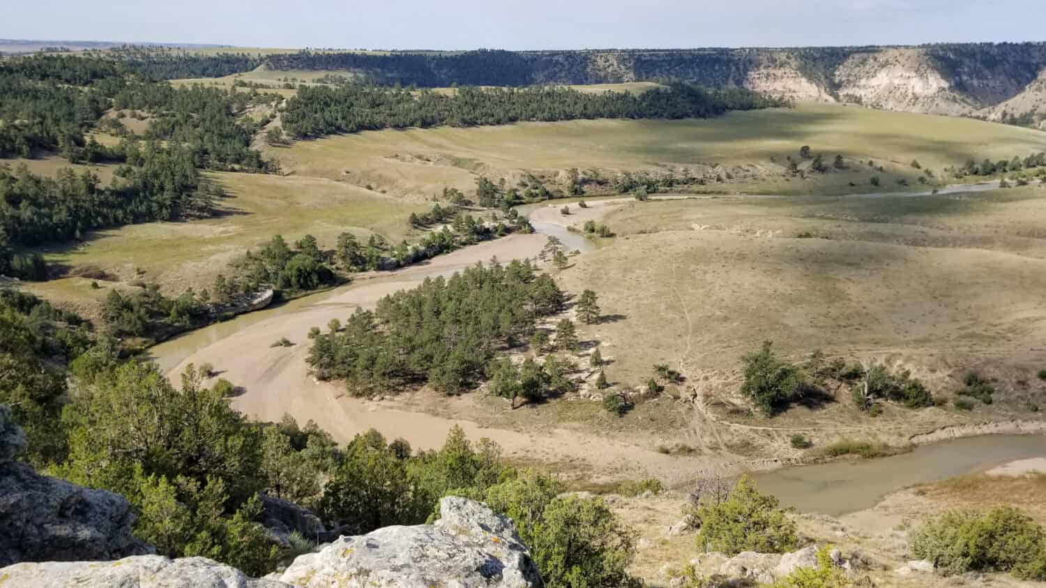 Wide panoramic view of Cheyenne River from viewpoint in Black Hills National Forest.
