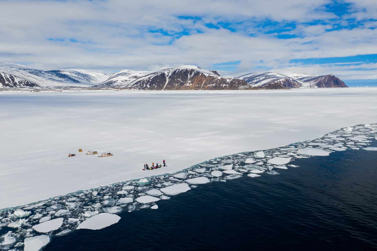 Aerial drone photo of tourists visit the floe edge near Sirmilik National Park in Nunavut, Canada