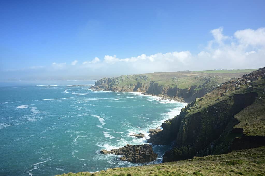 The Land's End under the sunlight and a blue sky at daytime in western Cornwall in England