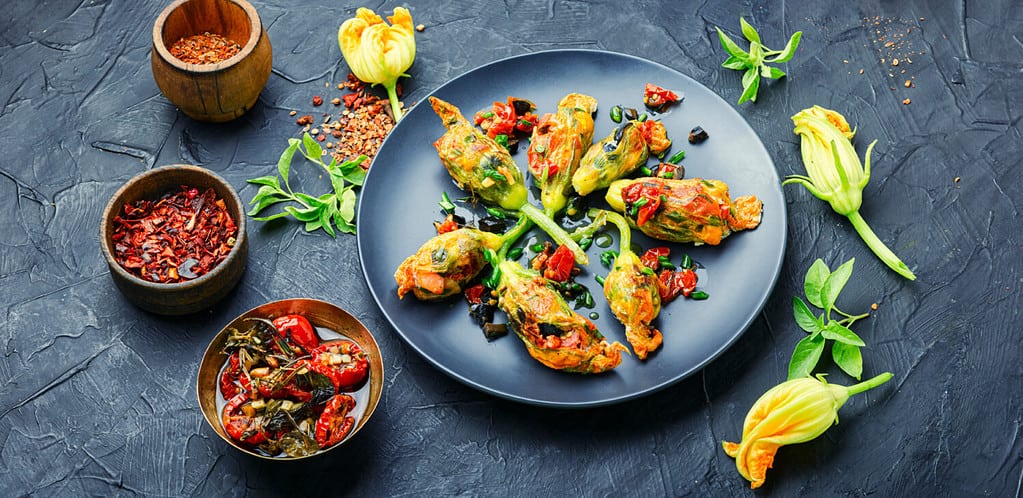 Delicious fried zucchini flowers stuffed with sun-dried tomatoes.Summer food.