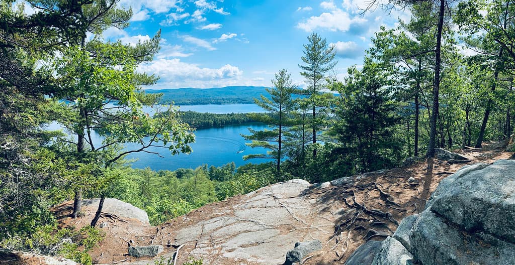 Panoramic view of newfound lake and follansbee cove near wellington state park beach from summit of Sugarloaf mountain near Bristol, New Hampshire (NH).