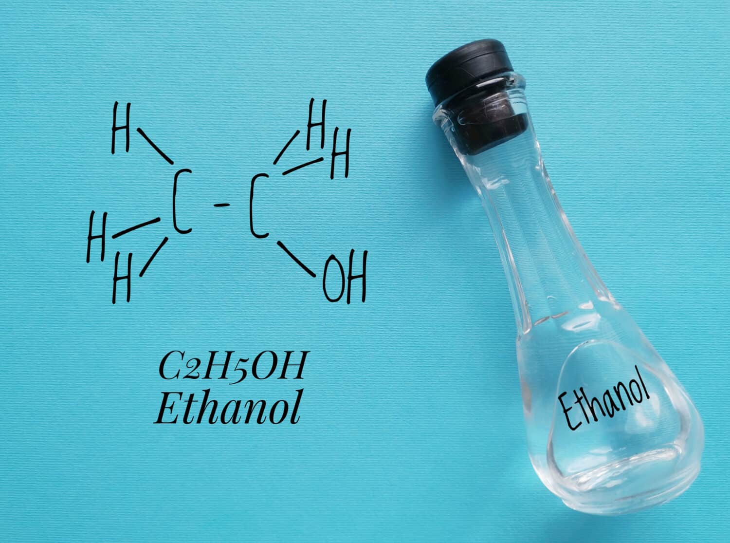 Structural chemical formula of ethanol molecule with a glass bottle of ethanol. Ethanol (ethyl alcohol) is a chemical compound, a simple alcohol with the chemical formula C2H6O.