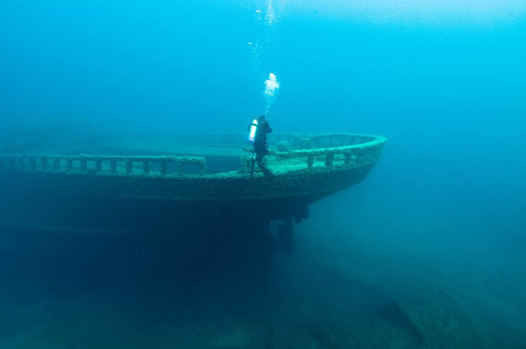 A diver inspects the bow of the wreck of the steel bulk freighter Grecian, where it rests in Lake Huron's Thunder Bay National Marine Sanctuary.