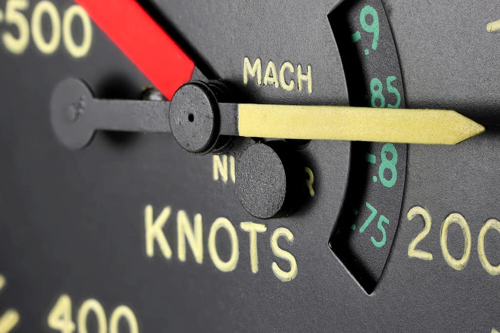 analogue airspeed indicator of jet aircraft shows speed in knots and mach
