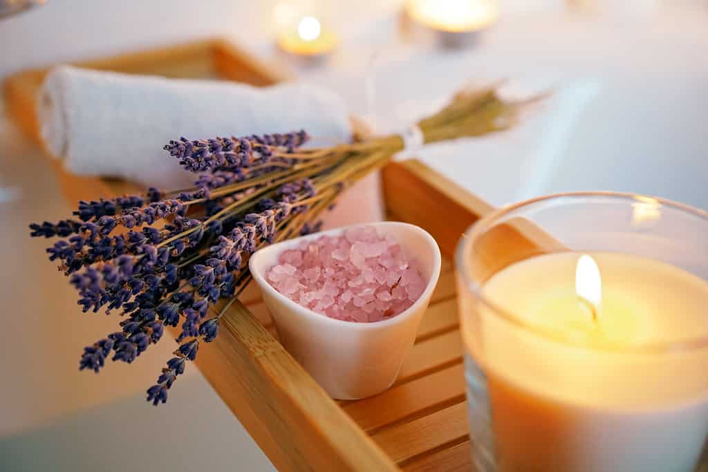 Candles, aroma salt and lavender on tub table