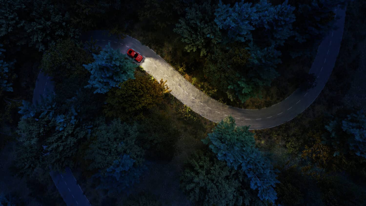Adventure night road trip in the forest, aerial view of a car headlights on deep jungle road. On The Road Again concept.