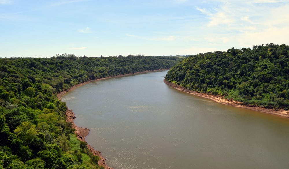 The border bend of the Parana River. The sky and the forest on the banks of the river.
