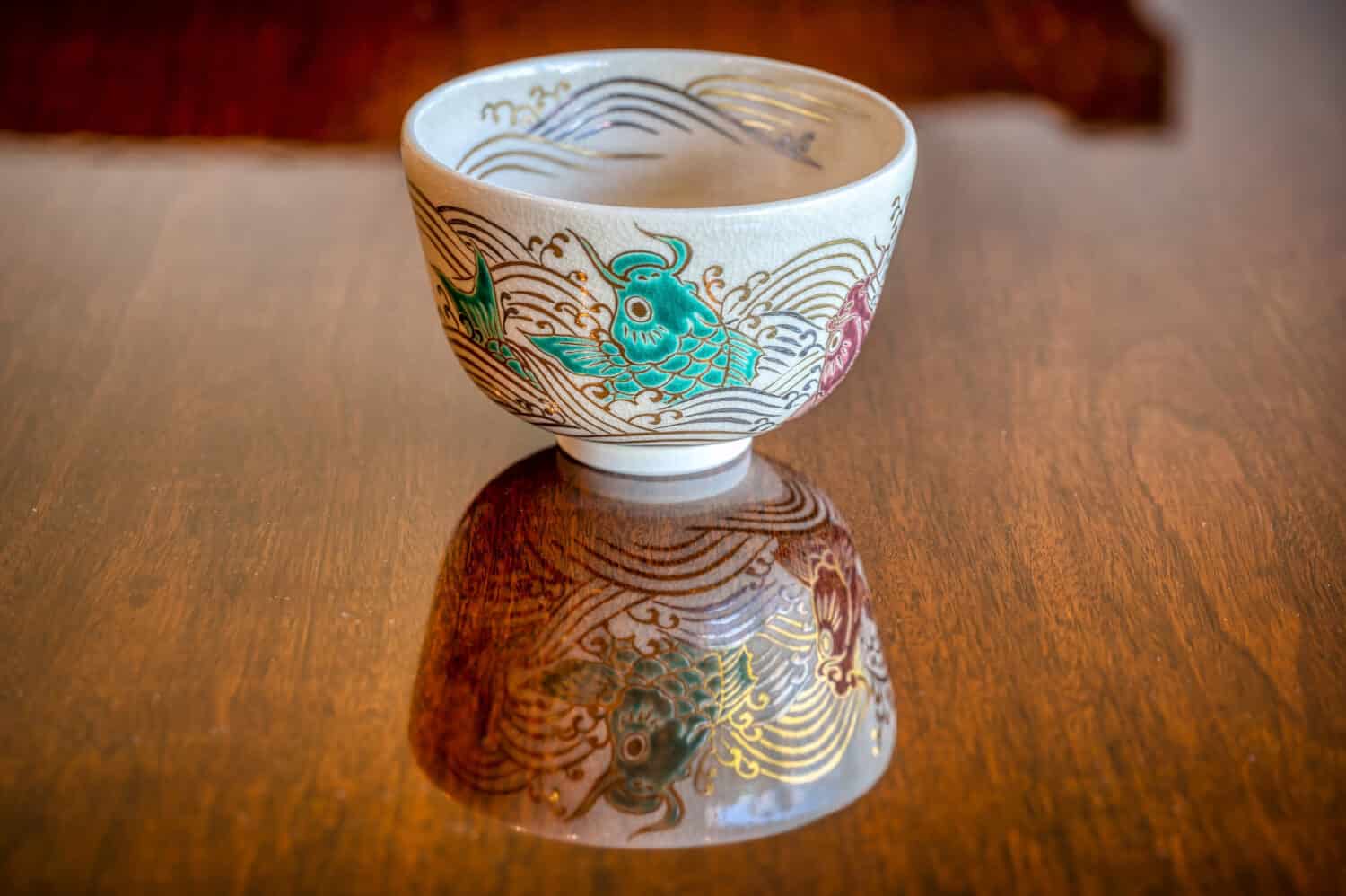 Kyoto rakuware tea bowl with koi carp and wave design, for use in the Japanese tea ceremony