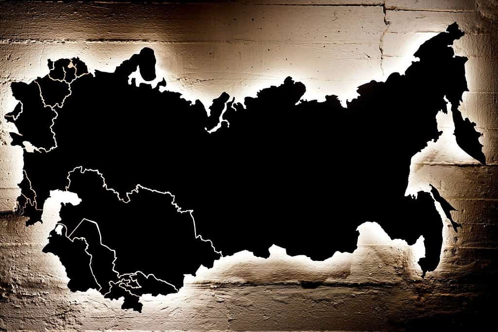A black map of Russia, Ukraine and 15 republics of the Soviet Union hanging on a cracked wall