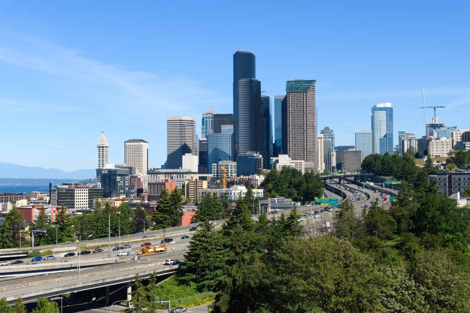 Cityscape view of the Seattle skyline with Interstate 5 on a sunny summer morning under a blue sky - June 2022
