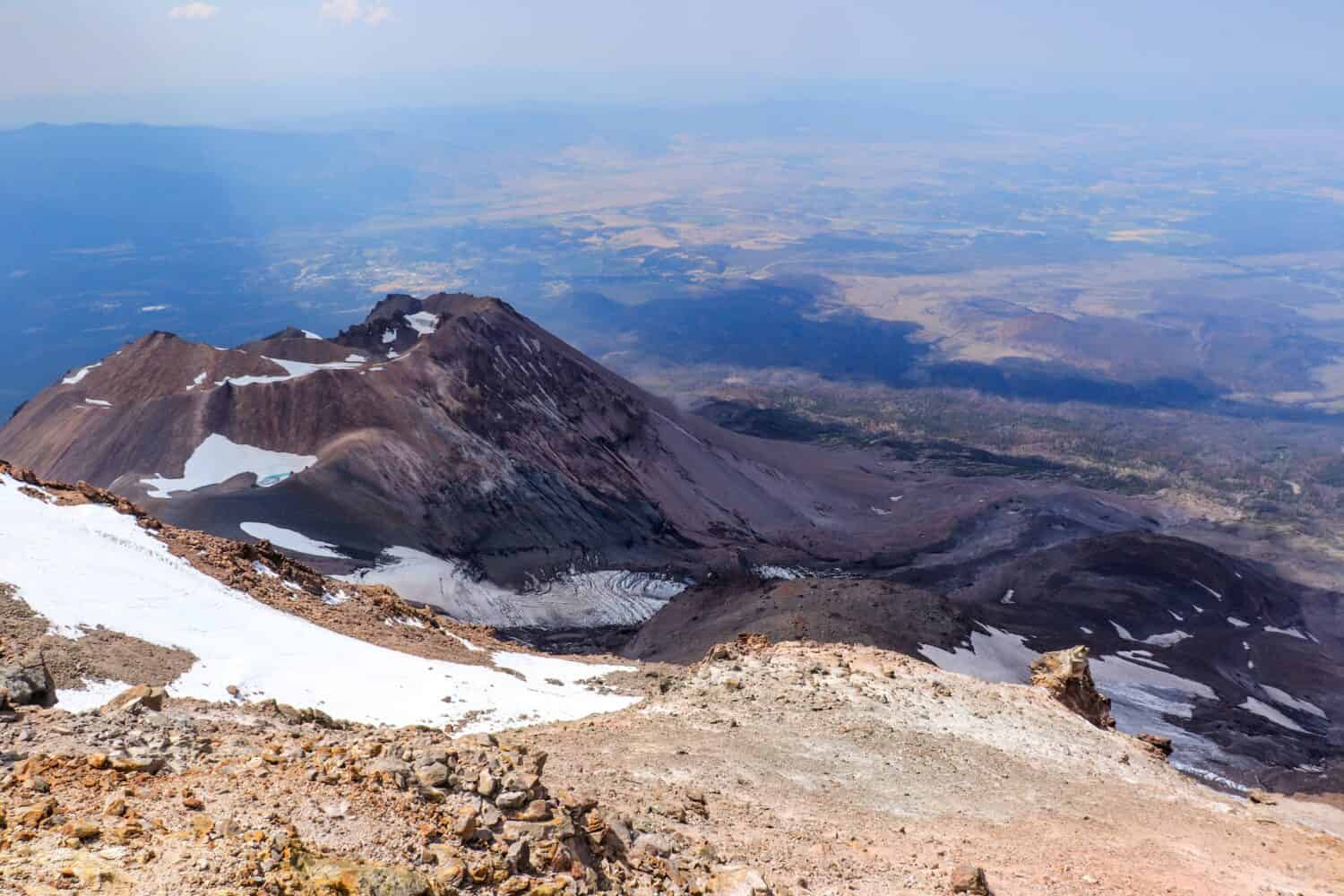 View into the northern California hazy with wildfires from the slopes of the volcano Mount Shasta, CA, USA in the summer 2022.