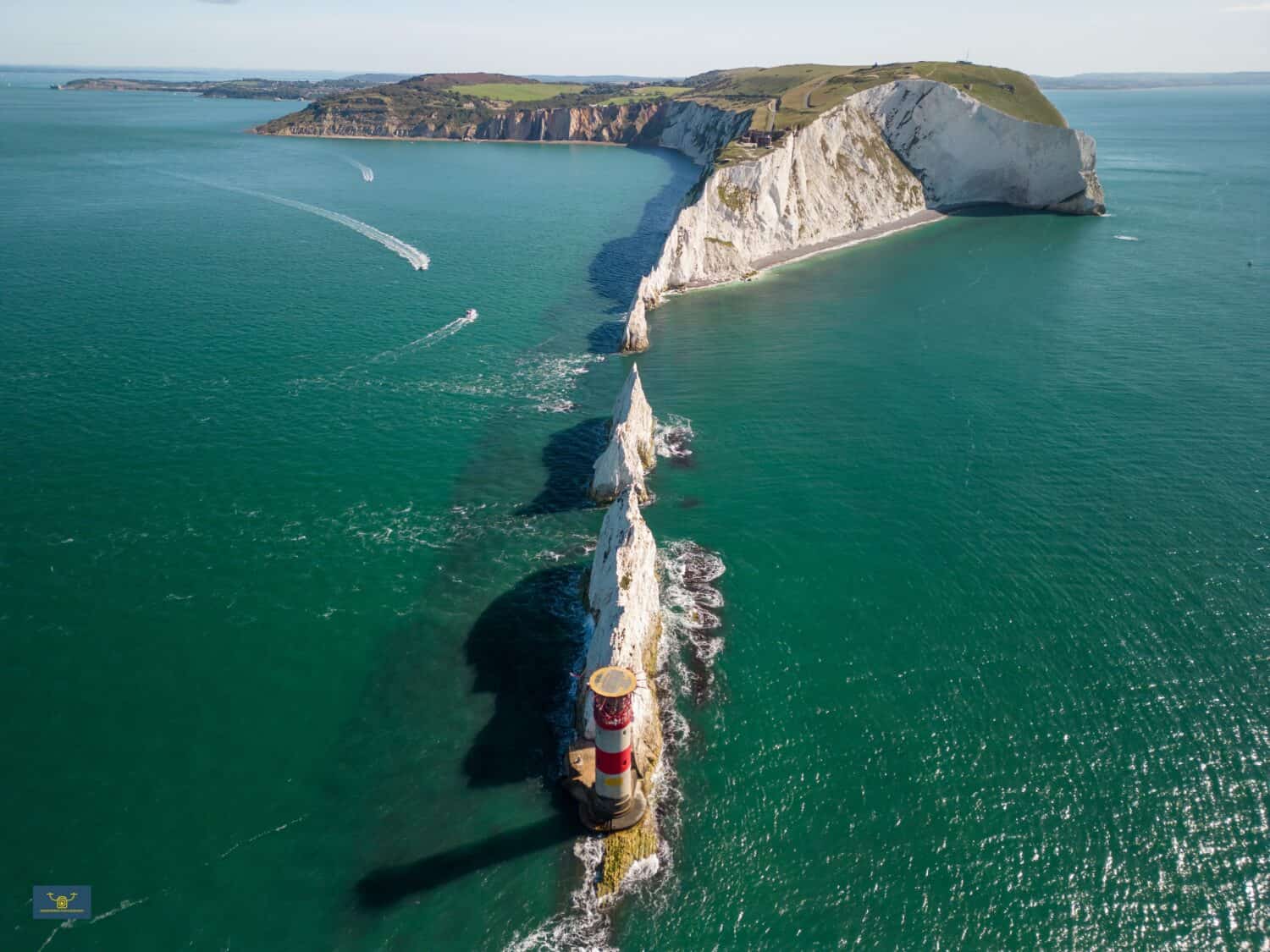The Needles Lighthouse, a prominent landmark on the Isle of Wight's coast, standing tall against a picturesque backdrop