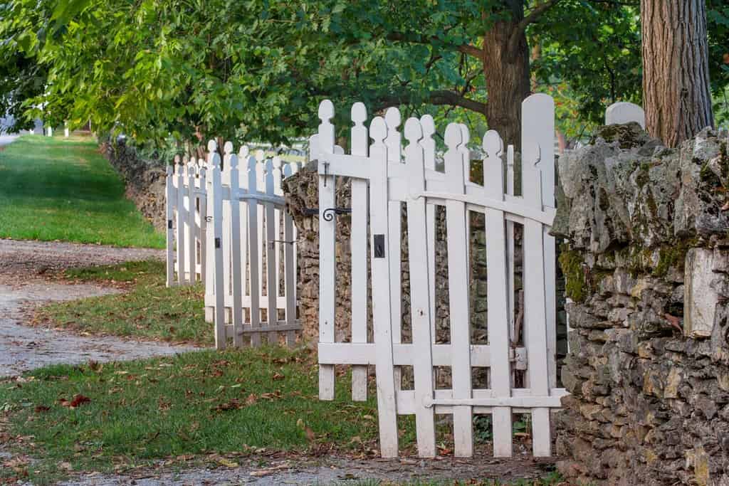 Gate and white wooden fence and rock wall, Shaker Village of Pleasant Hill, Harrodsburg, Kentucky
