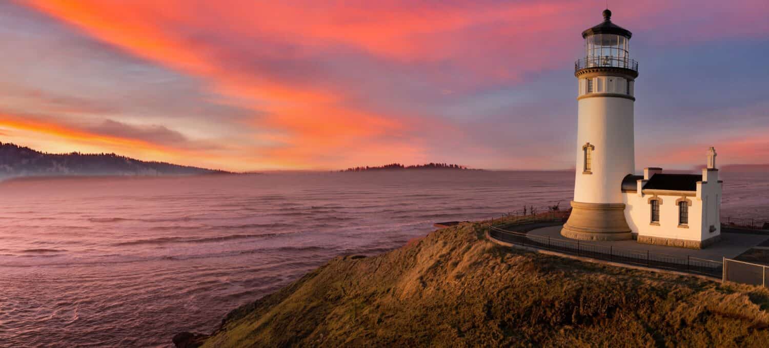 North head lighthouse at the mouth of the Columbia River at a headland at sunset on the south Washington state coast