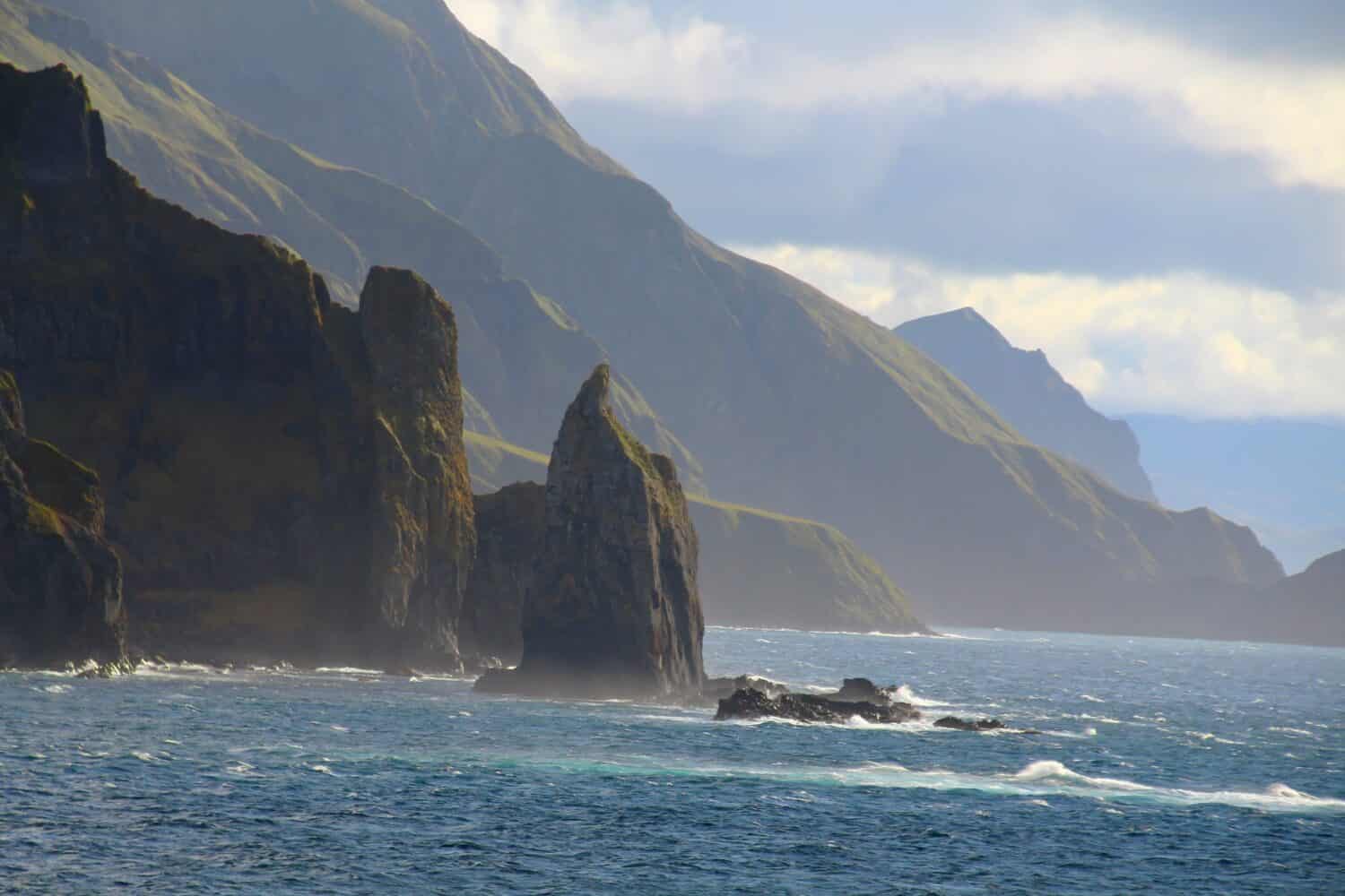 Alaska-Coast of Unalaska Island in the foreground Priest Rock-Aleutian Islands, United States