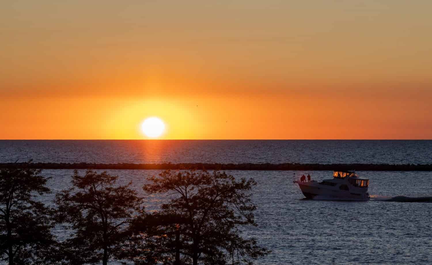 Boat shipping into the sunset on one of the Great Lakes, Lake Erie, Cleveland, Ohio