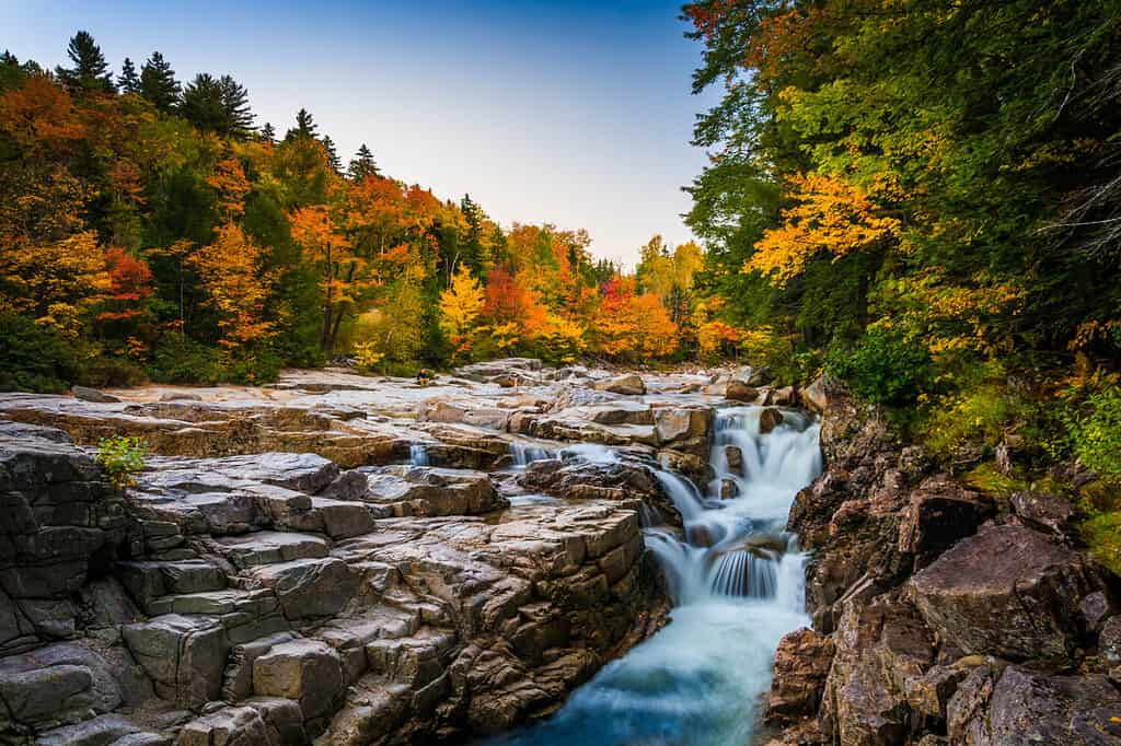 Autumn color and waterfall at Rocky Gorge, on the Kancamagus Highway, in White Mountain National Forest, New Hampshire.