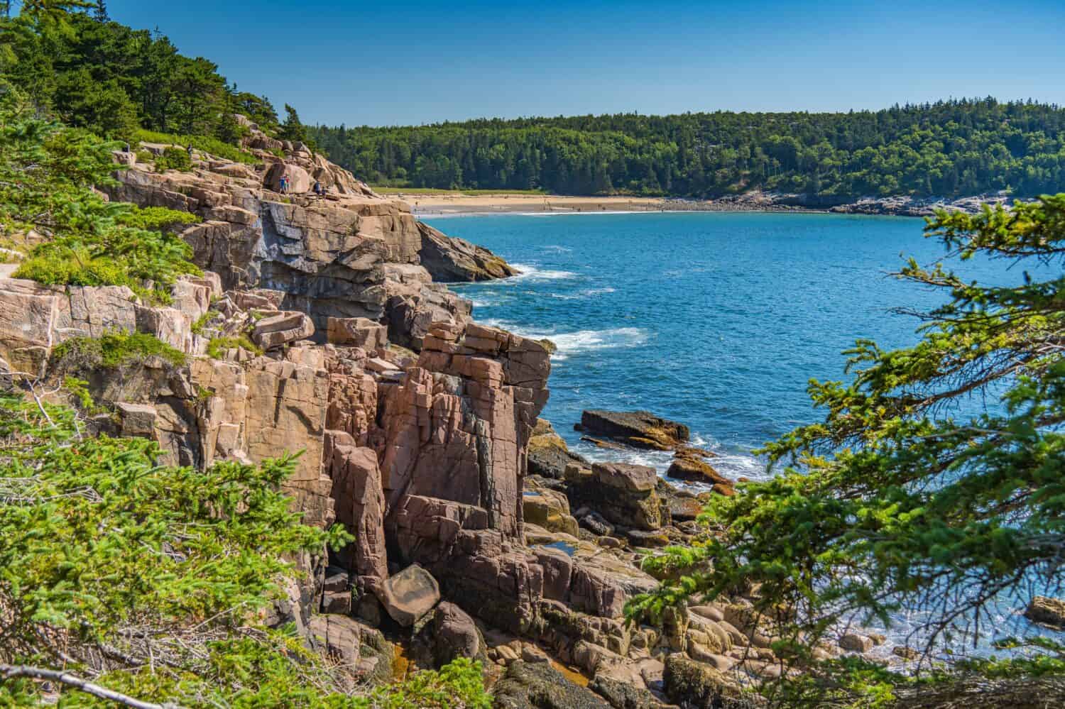 Sand Beach in the distance of rocky coastline at Arcadia National Park in Maine.