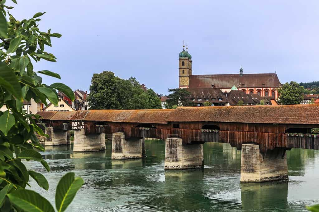 The Rhine with the historic wood bridge and Fridolins munster in Bad Saeckingen at summer, Germany