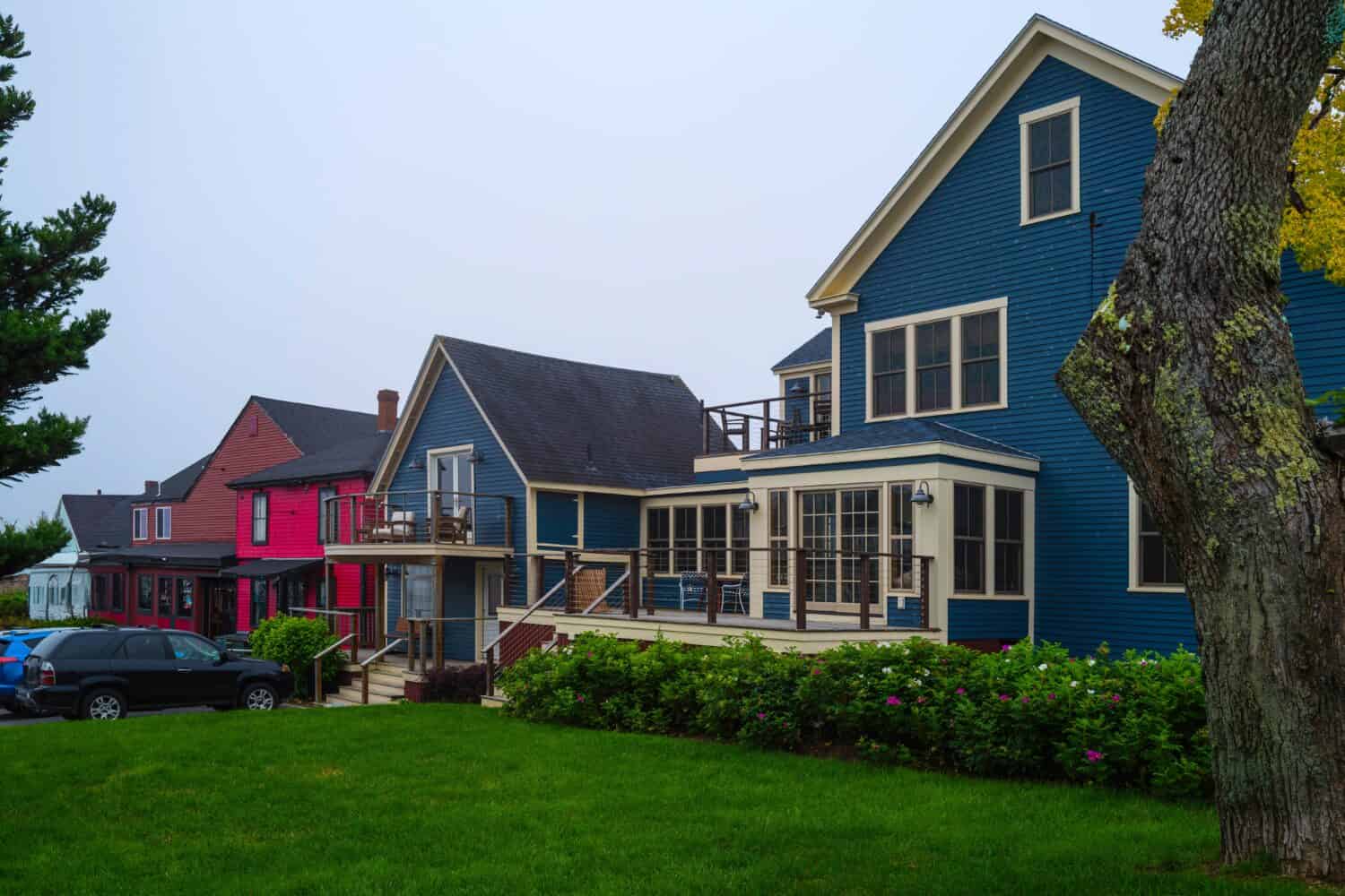 Vibrant buildings and garden in a small town shopping mall in the coastal village of New England. Charming summer travel landscape of Boothbay in Lincoln County, Maine.