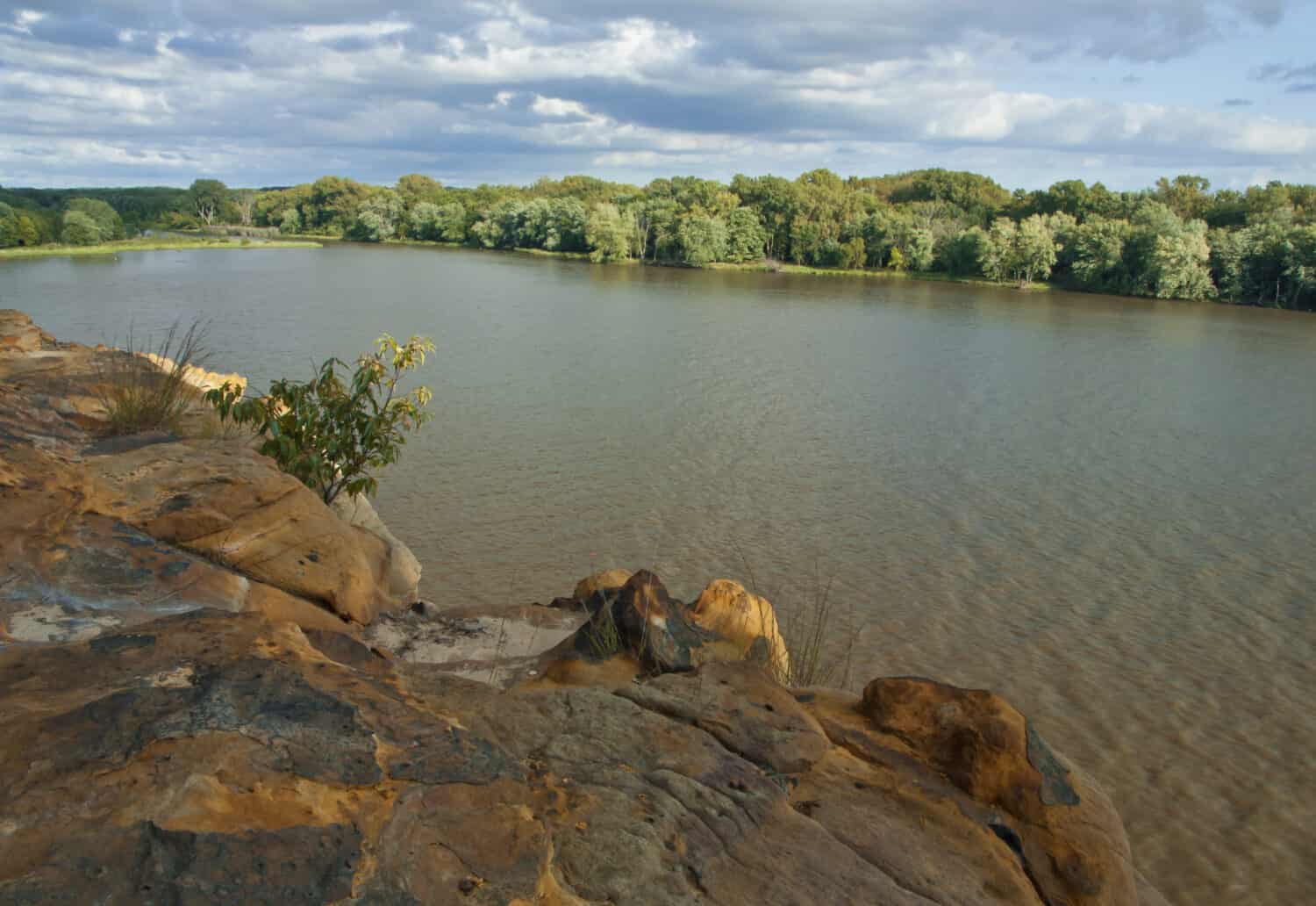 The Illinois River flows lazily by bluffs at Buffalo Rock State Park on a summer's evening