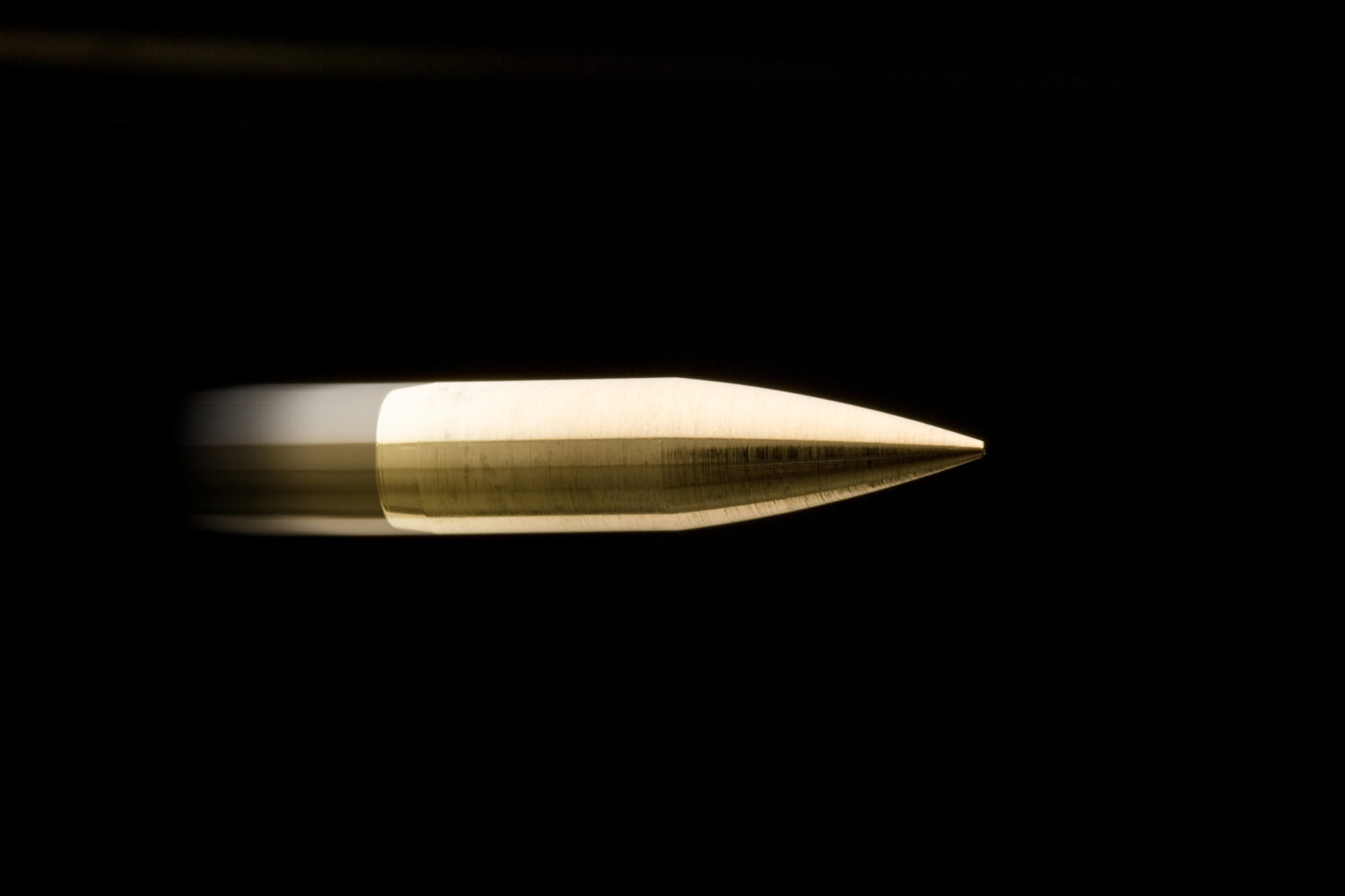 Flying bullet isolated on black background