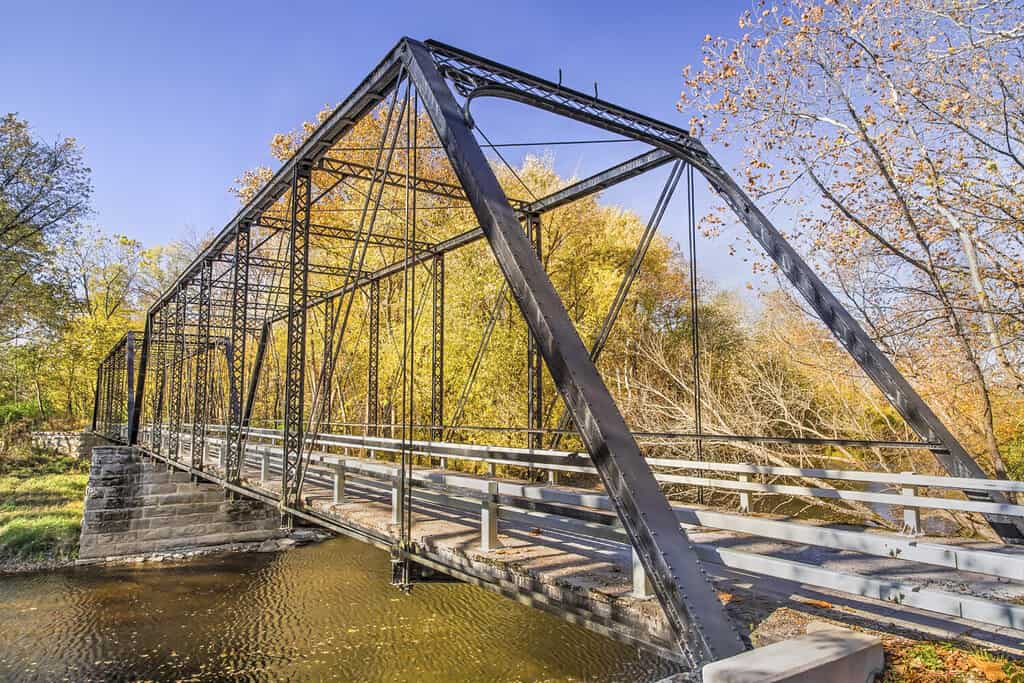 Built in 1885, the Furnas Mill Bridge, a two span pinned Pratt through truss of wrought iron and steel, crosses Sugar Creek in Johnson County, Indiana.