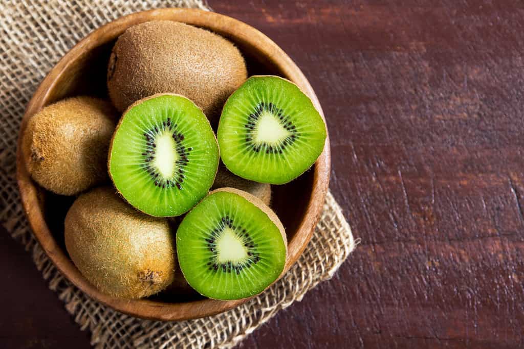 Kiwi fruit on wooden background with copy space