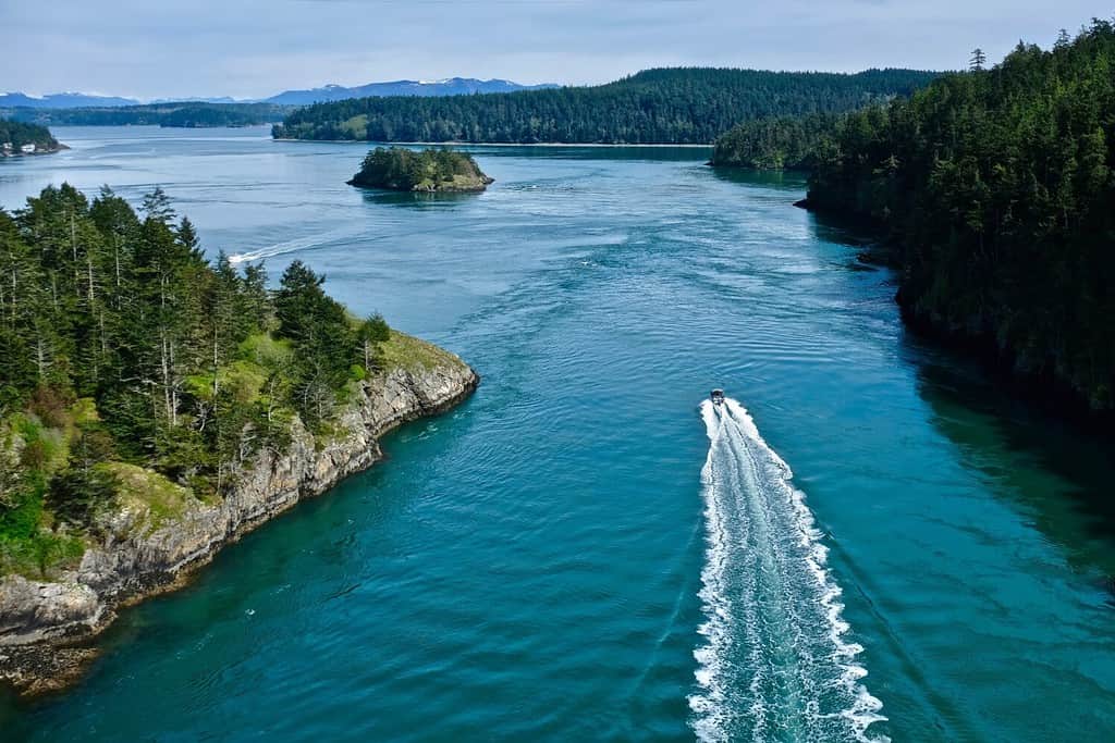 Boat in the ocean among islands. Deception Pass State Park. Puget Sound. WA. United States.