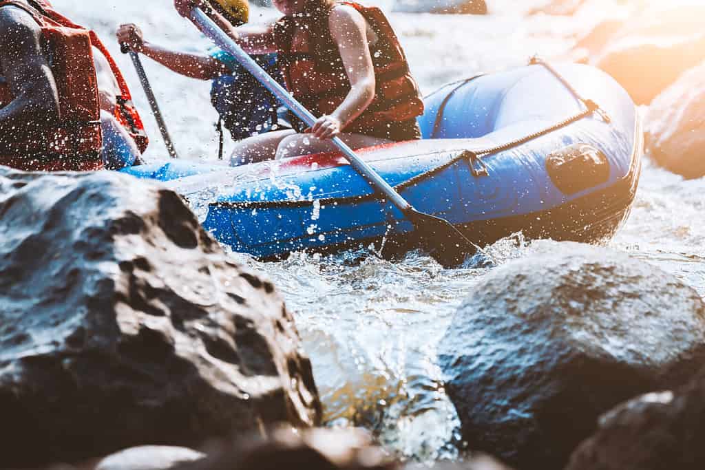 Young person rafting on the river, extreme and fun sport at tourist attraction