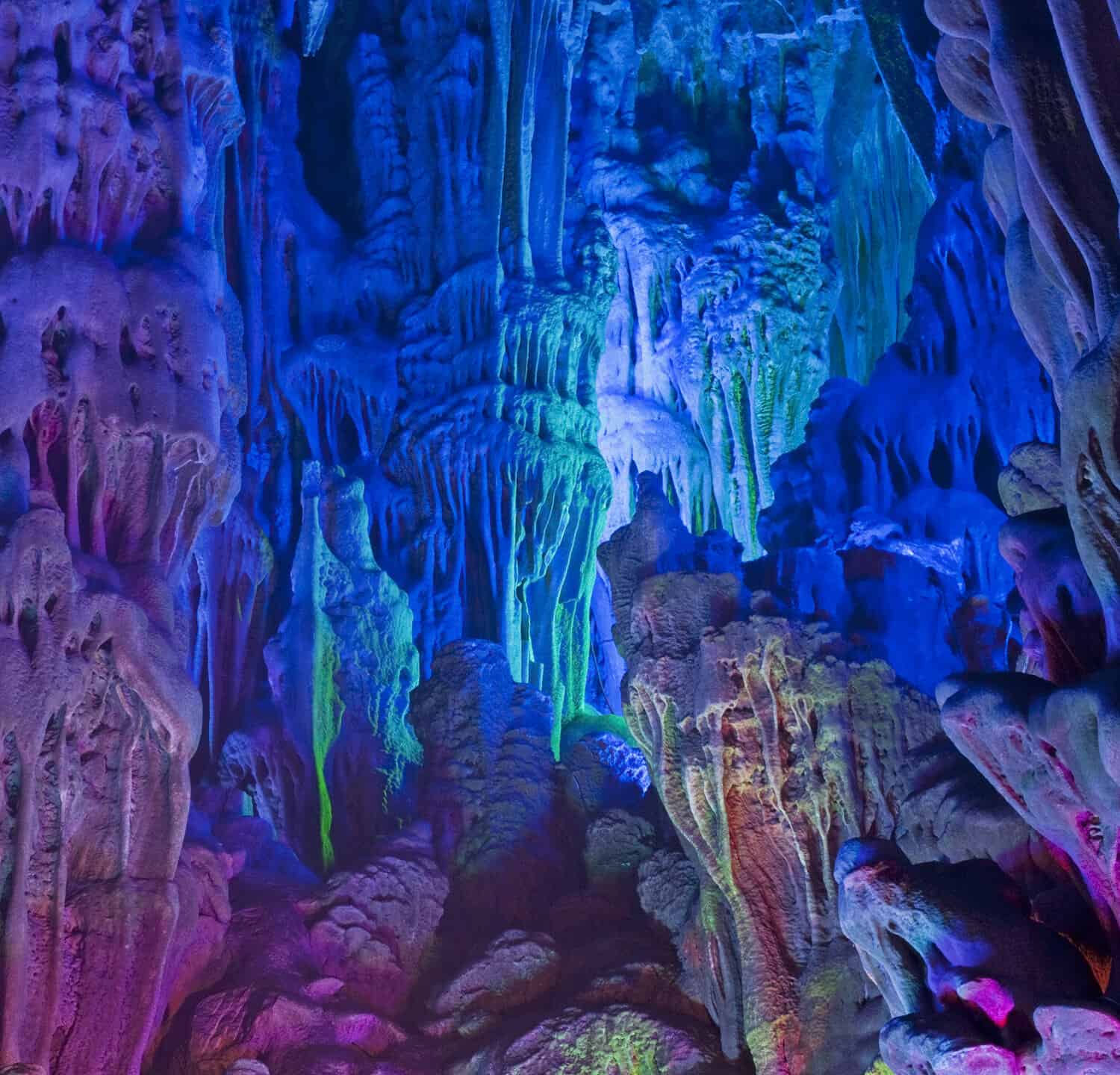The beautifully illuminated Reed Flute Caves displaying the "Morning Sunrise over the Lion Jungle" formations. Located in Guilin, Guangxi Provine, China